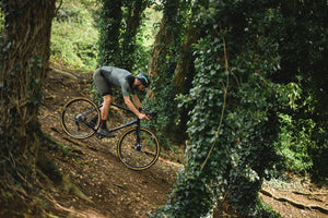 Kinesis GX Race being ridden down a slope in the woods.