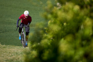 Kinesis Tripster AT Plus black being ridden up a hill.