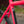 Close-up of a bright pink bicycle frame with a black and white 4S Disc logo decal on the seat tube, with a blurred outdoor background.