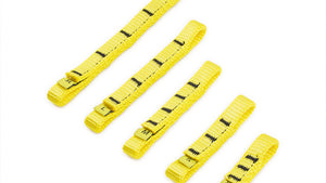 Five Wholegrain Cycles yellow Load straps of varying widths and lengths, arranged diagonally on a plain white background. Each strap features black printed measurement markings and a metal buckle at one end.