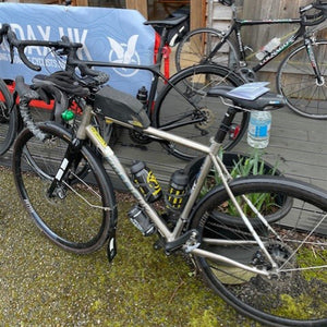 Bicycles parked on a wooden deck with a blue tarp in the background