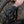 Person wearing black mamba gloves adjusting a bicycle chain.