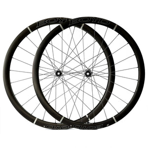 Two black Boyd Cycling 36mm Carbon  road cycling wheels with black spokes, overlapping on a solid white background. 
