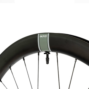 Close up of a Boyd Cycling 44mm Carbon Road Wheel rim showing the logo and valve on a white background