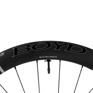 Boyd Cycling 55mm SL Road Bike disc brake carbon wheel rim close up of the logo and valve on a white background