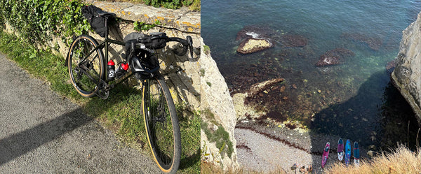 Bicycle leaning against a stone wall with a coastal scene featuring people on a path.