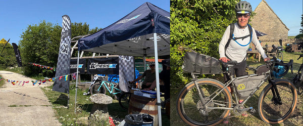 Bicycle race setup with tents and a cyclist on a bike in a scenic area.