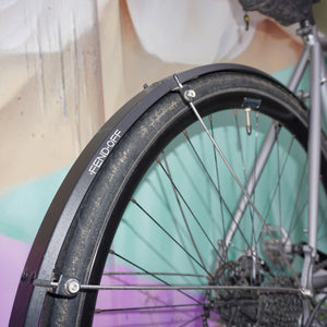 Rear Fend Off on a bike next to a graffitied wall