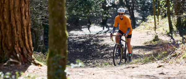 Fran riding a Tripster on the South Downs in an orange top