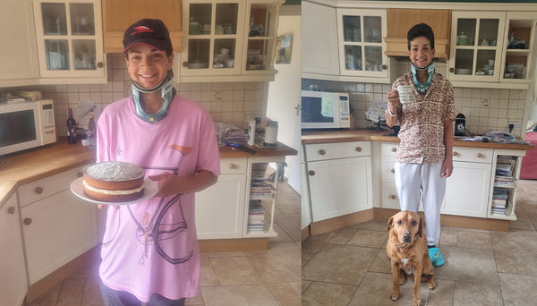 Fran holding a cake in a kitchen, followed by a person standing with a dog in the same kitchen.