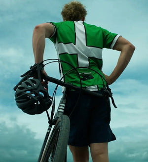 Image of Joshua Moodie looking at his back as he stands with his Kinesis Tripster AT Plus with a helmet resting on the handlebars.