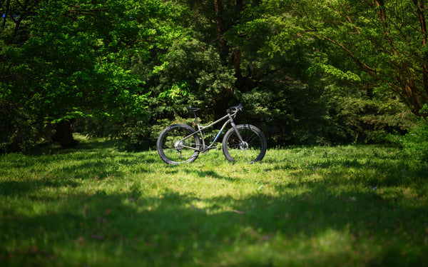 Fernweh MTB fully built in a grassy field for use on the frame pdp as a banner