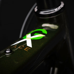 Close up of the GX race logo on the top tube on the green frame.