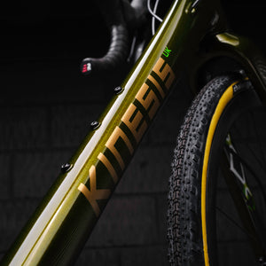 Close-up of a GX green frame with 'Kinesis' branding on a dark background.