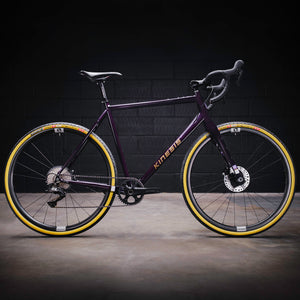 Kinesis GX Frameset in purple taken in a warehouse
