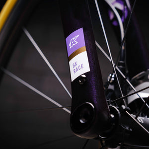 Kinesis GX Frameset in purple taken in a warehouse, closeup of fork logo.