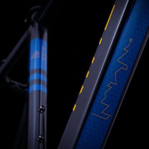 Kinesis Tripster AT midnight blue down tube logo on a black background.