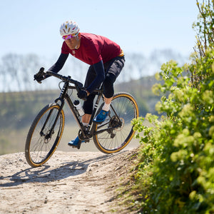 Tripster AT Plus being ridden off road on a dusty trail.