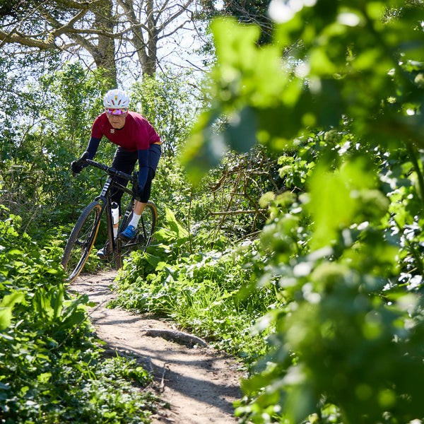 Tripster AT Plus being ridden on a twisty wooded trail.