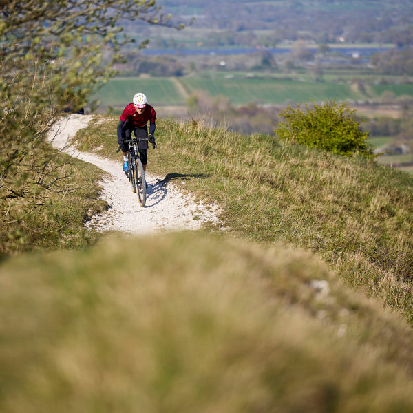 Tripster AT Plus being ridden on a trail in the sunshine.
