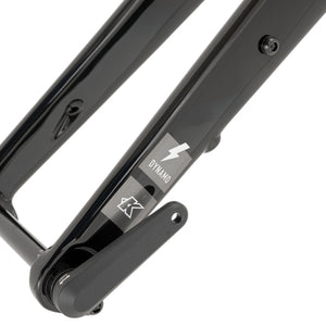 Close-up of a black carbon bicycle fork with a visible Dynamo brand decal on a white background.