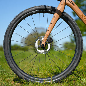 Bicycle wheel with Kinesis gravel all terrain fork on grass and disc brake