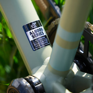 Close-up of a gravel bicycle frame with an 'AL6061 Series' aluminum label.
