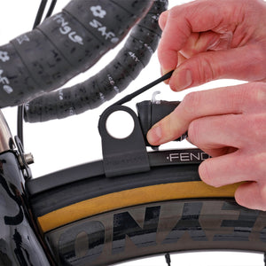 Fend off light mount with a light being fitted on a bike. 