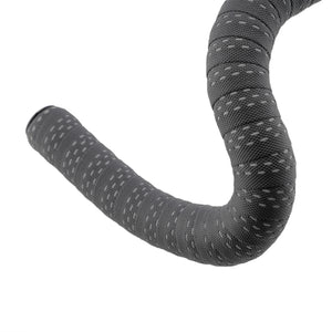 A curved bicycle handlebar tape wrap in dark gray with a textured pattern of small light gray dots, shown against a plain white background.