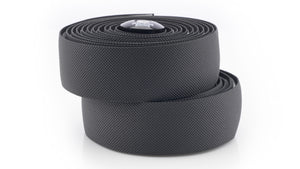 Two coiled black textured Kinesis 4 Seasons 2.5mm bicycle handlebar tape rolls stacked on a white background.