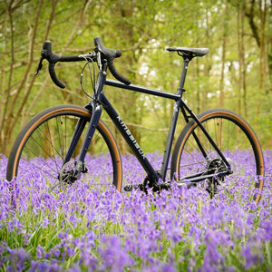 Kinesis G2 Bike in Blue in a Bluebell woodland