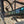 Close-up of a bicycle frame with 'Kinesis' branding against a brick wall.