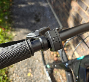 Close-up of a bicycle handlebar with battery control