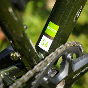 Close-up of a bicycle chain and gear system with 'Scandium' branding.