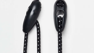 Black and white adjustable Wholegrain Cycles bungees with stitching and two black plastic toggle sliders, shown on a clean white background.