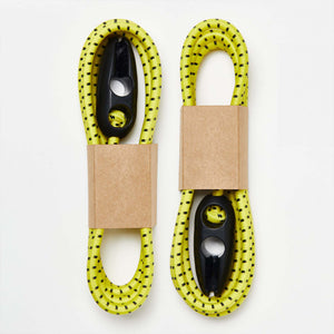 A pair of Wholegrain Cycles yellow and black bungees with their cardboard brackets on a white background.