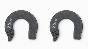 Two black horseshoe-shaped plastic spacers with the number 25.4 printed in white on the left side, shown on a plain white background.