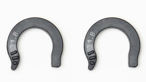 Two dark gray horseshoe-shaped plastic spacers with white measurement markings, 31.8mm displayed side by side on a plain white background.