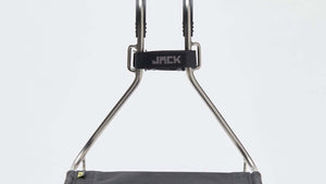 A Wholegrain Cycles Jack Classic bike rack with a black fabric seat and silver metal frame, shown against a plain white studio background.