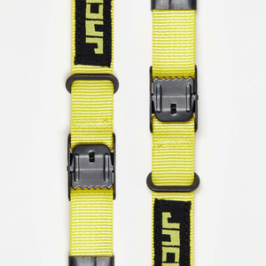 Two Wholegrain Cycles Stiff Straps with black plastic buckles and black fabric tabs printed with a stylized green logo, shown on a plain white background.