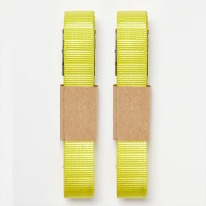 Two bright yellow Wholegrain Cycles Stiff Straps with brown kraft paper bands, shown vertically on a plain white background.